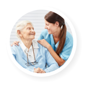 female caregiver and her old woman patient smiling to each other