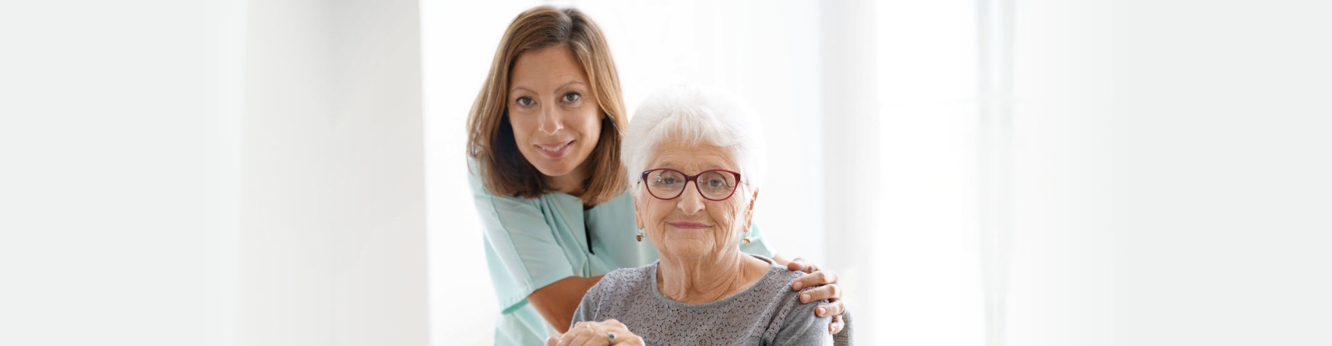 female caregiver with her old woman patient